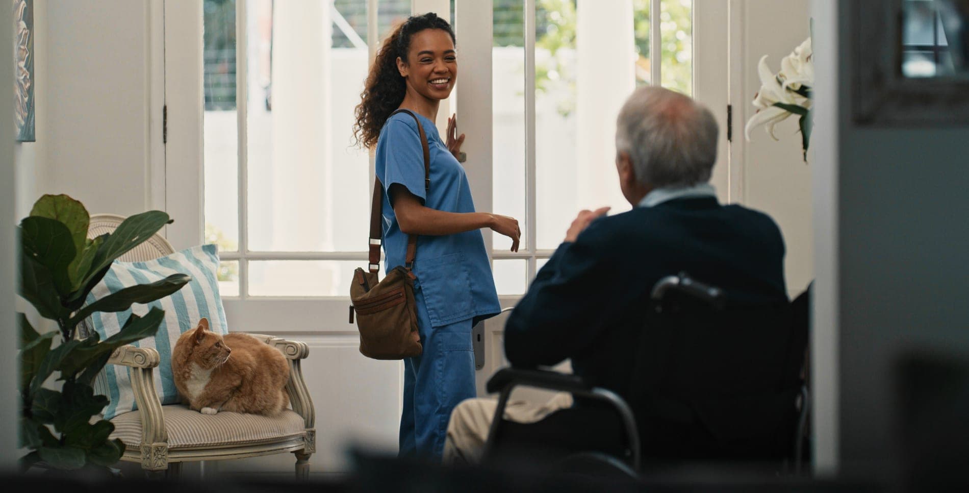 A carer supporting a client during a home visit