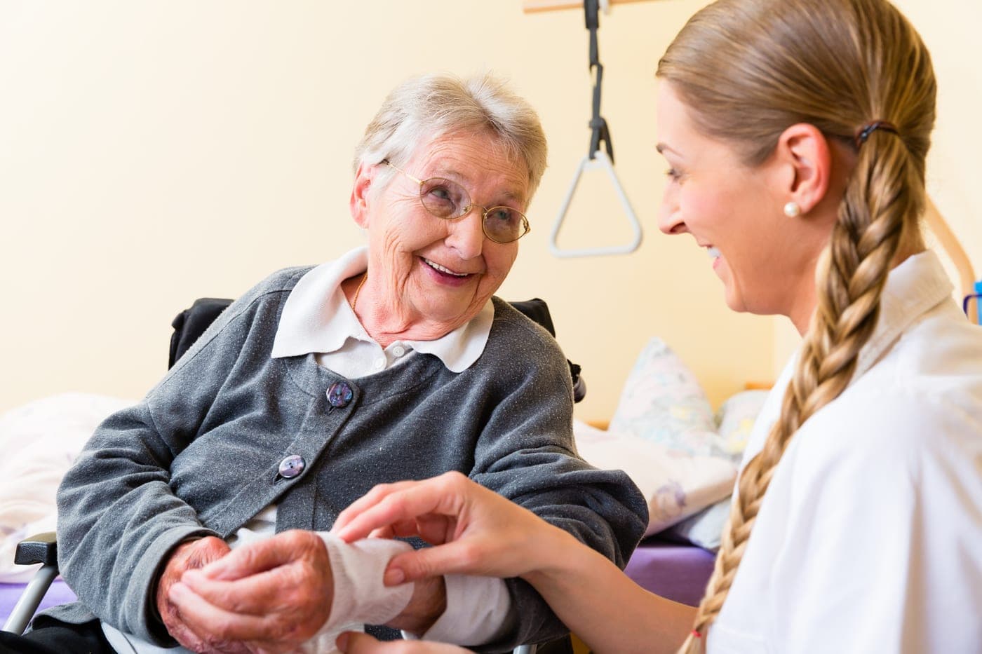A carer sharing a warm moment with an older woman at home